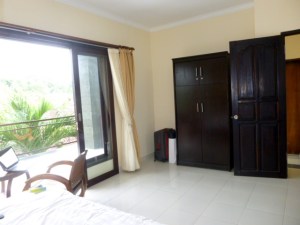 And the wall opposite the bed with a large lumari, aka wardrobe. The door is open. My door is always open unless I'm asleep.